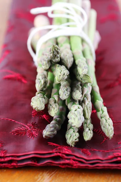 Green asparagus on red napkin — Stock Photo, Image