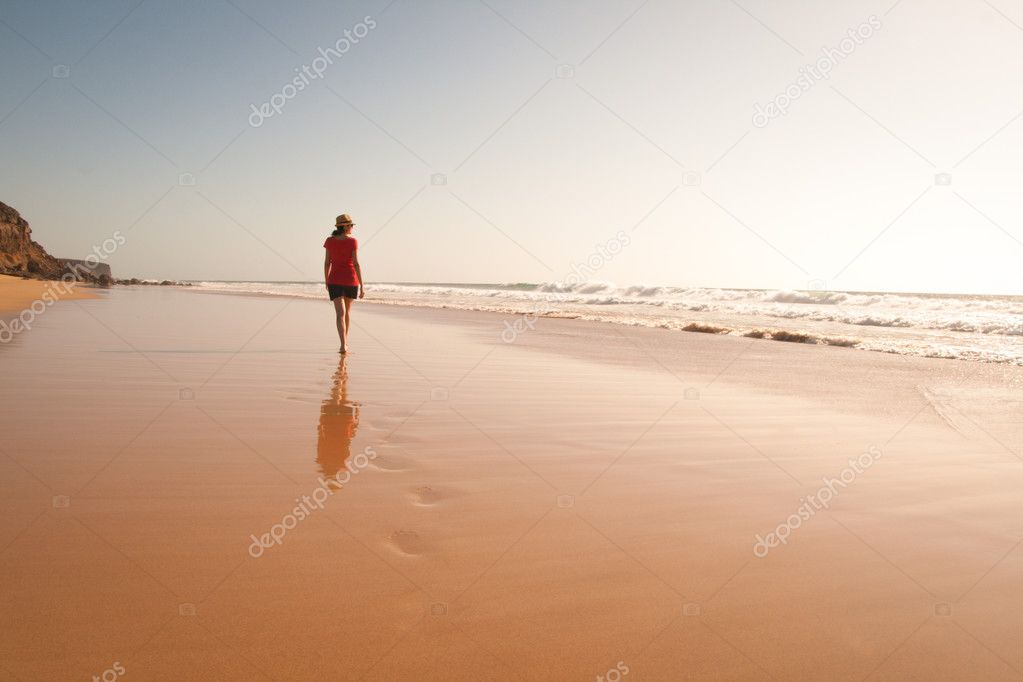 Solitary girl walking on the beach