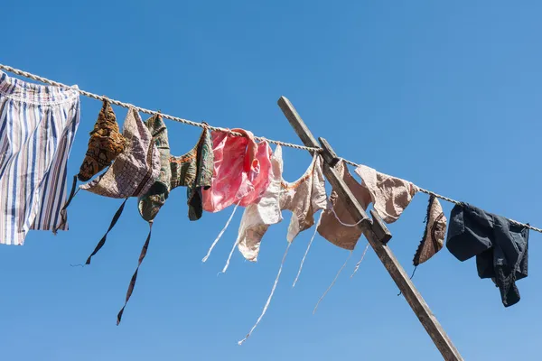 Clothesline with traditional Dutch clothes drying in the wind — Stock Photo, Image