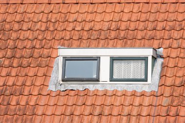 Typical Dutch roof with dormer and squared windows clipart