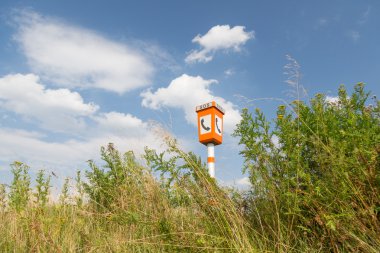 Emergency call post in a rural landscape clipart