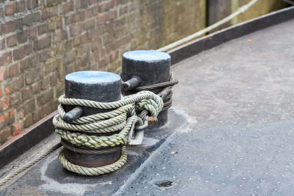 Rope tied to steel bollard on ship deck — Stock Photo, Image