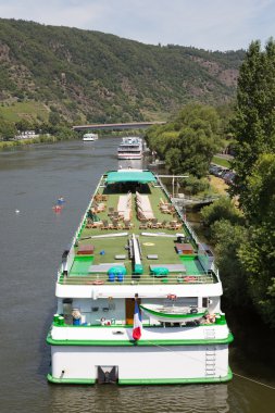 Cruise ships near Cochem at the river Moselle in Germany clipart