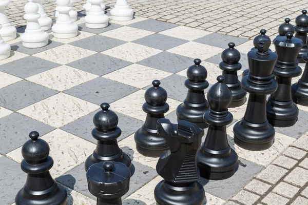 Outdoor chess board with big plastic pieces — Stock Photo, Image