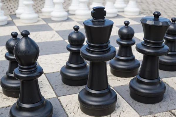 Outdoor chess board with big plastic pieces — Stock Photo, Image