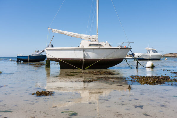 Small boats at ebb tide in Brittany, Franc