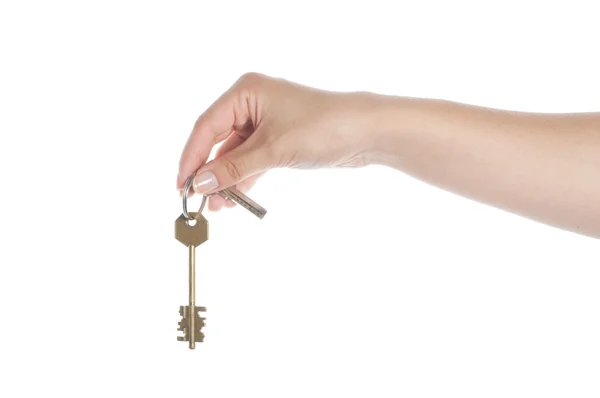 Hand holding a key on a white — Stockfoto