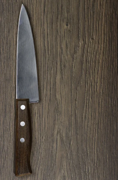 stock image Knife on rustic kitchen table with space