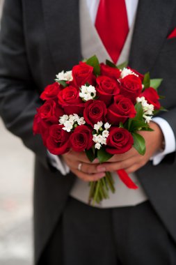 Groom showing her rose bouquet clipart