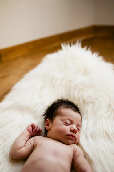 Sweet newborn sleeping on a white carpet — Stock Photo, Image