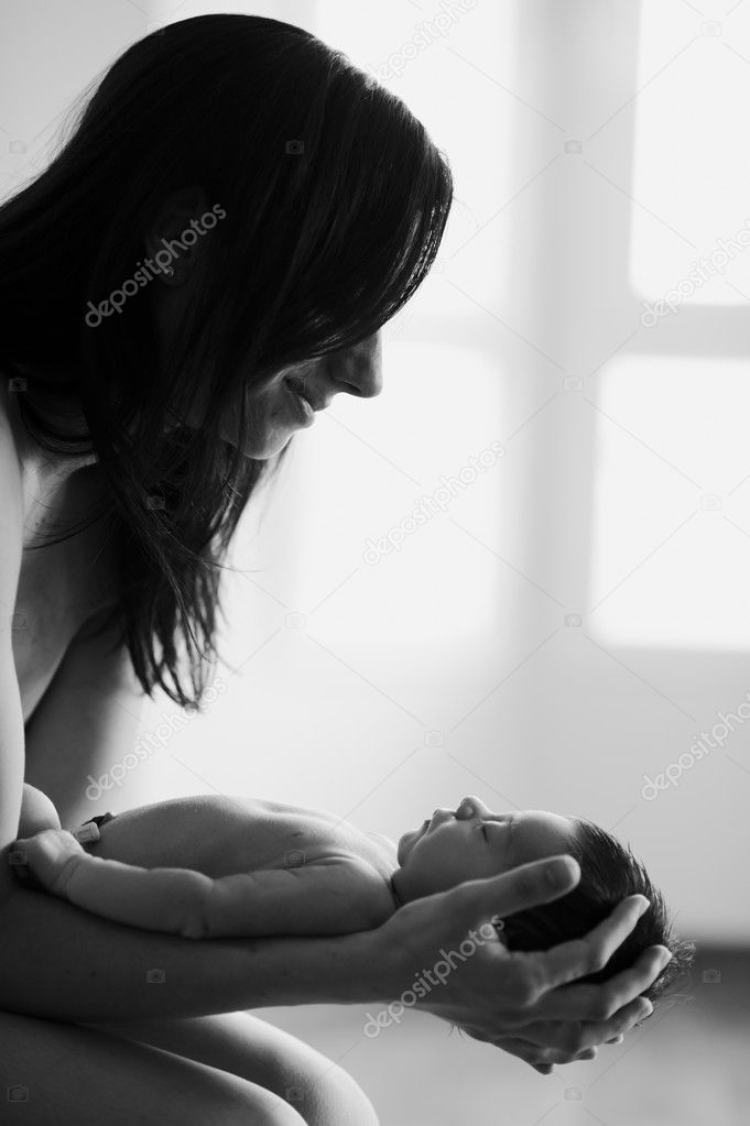 Mother looking at her newborn with love