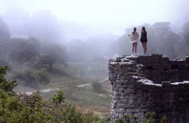 Women Overlooking Bright Foggy Valley clipart