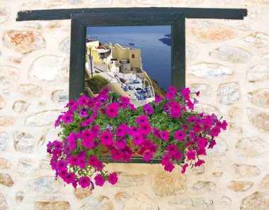 Traditional greek house through an old window in Santorini island, Greece clipart