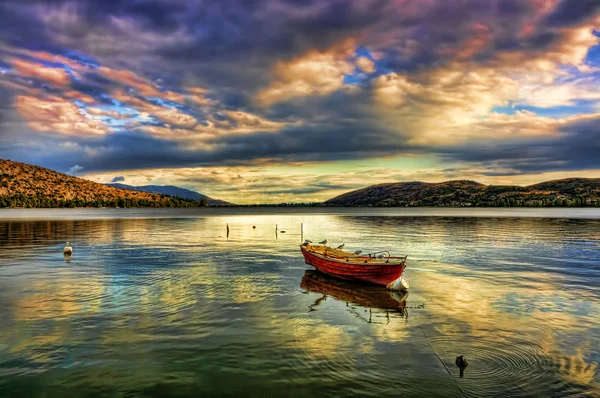 Traditional fishing red boat at sunset time in lake — Stock Photo, Image