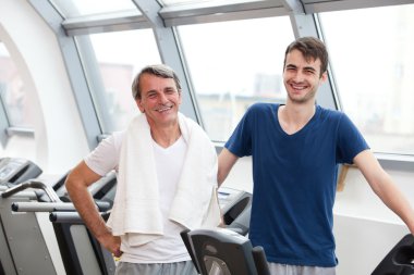 Gym training, young man and his father clipart