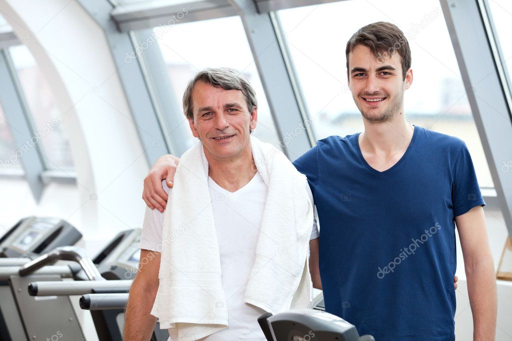 Gym training, young man and his father