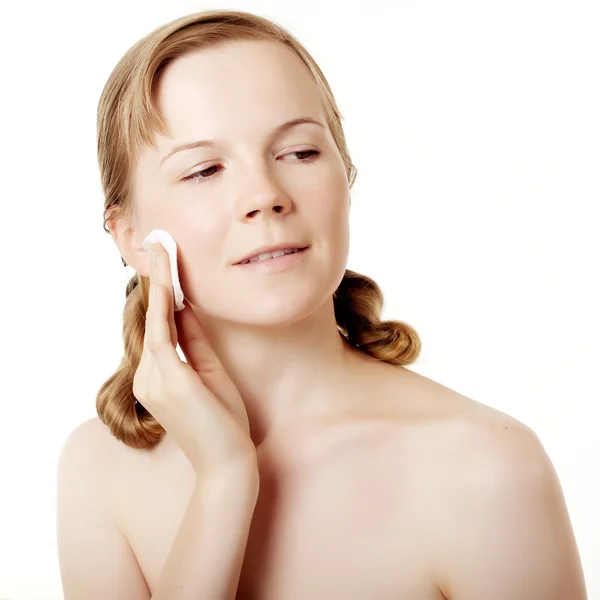 Girl puts on skin cream — Stock Photo, Image