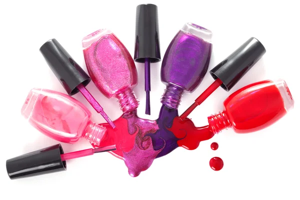 Ñolored nail polish spilling from bottles — 스톡 사진