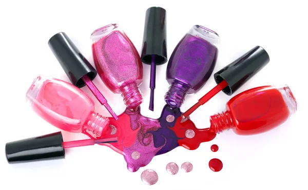 Ñolored nail polish spilling from bottles — 스톡 사진
