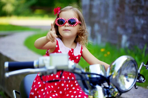 Girl in a red dress on a motorcycle — Stock Photo, Image