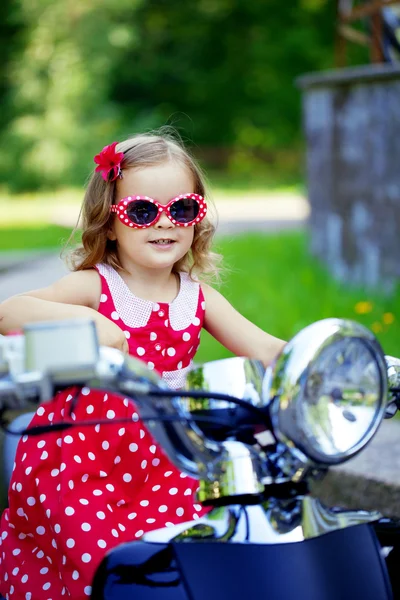 Girl in a red dress on a motorcycle — Stock Photo, Image