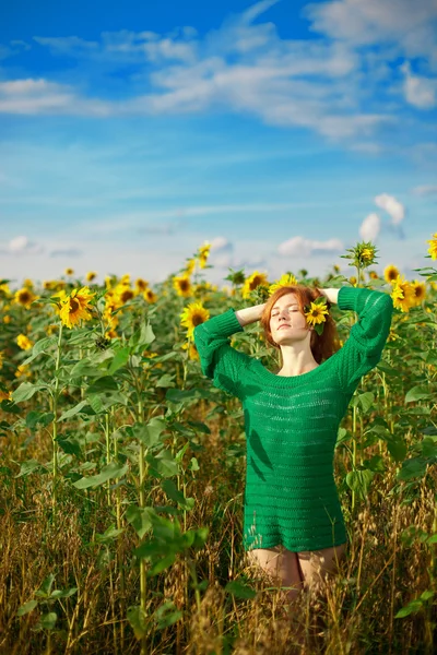 Red-haired woman with sunflowers — Stock Photo, Image