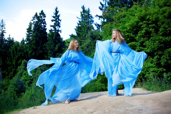 Two woman, twins in the forest Stock Photo