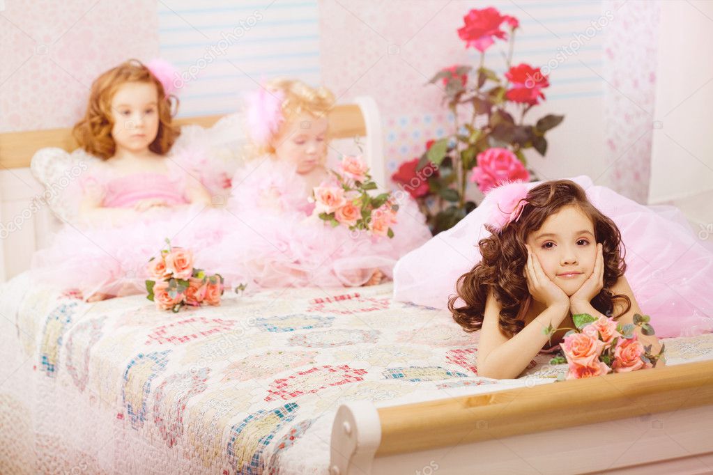 Children in the nursery in pink dresses