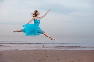 Ballerina dancing on the beach clipart