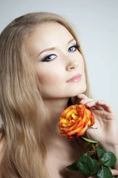 Beautiful woman with a rose — Stock Photo, Image
