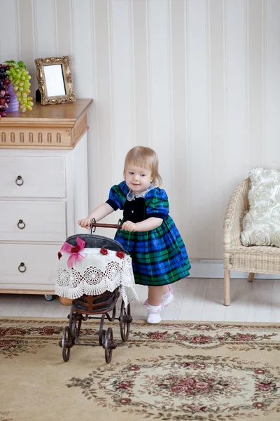 Menina bonito com carrinho de brinquedo — Fotografia de Stock
