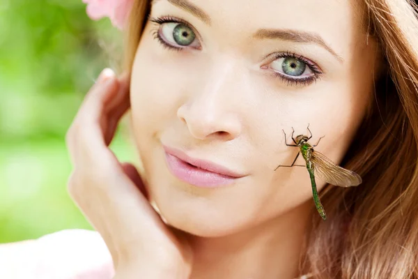 Woman with a dragonfly on her face — Stock Photo, Image