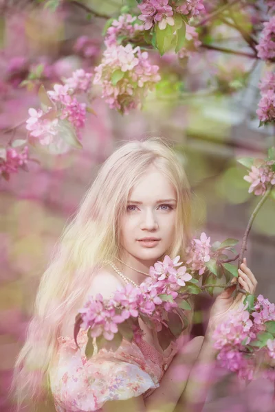 Beautiful woman and flowering tree — Stock Photo, Image