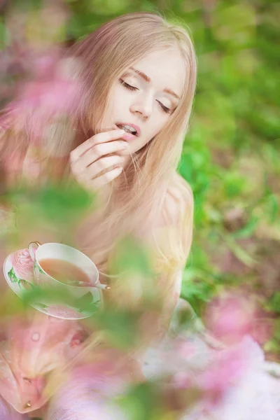 Beautiful woman with flowering tree — Stock Photo, Image