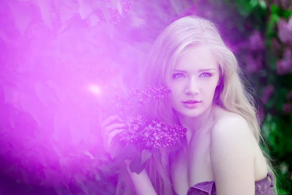 Woman with a lilac flowers. — Stock Photo, Image