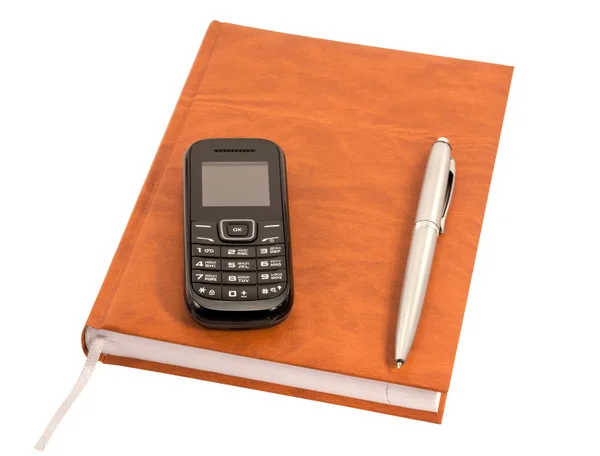 Diário fechado com caneta e telefone celular — Fotografia de Stock