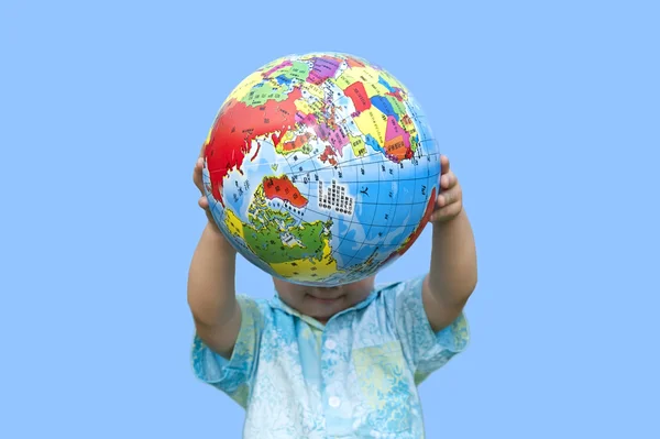 stock image Boy holding the earth model under blue sky
