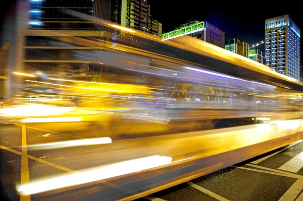 Hohe Geschwindigkeit und verschwommene Busspuren in der Innenstadt — Stockfoto
