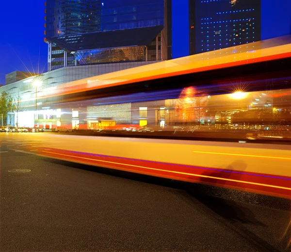 Υψηλής ταχύτητας και το φως μονοπάτια θολή λεωφορείων στο κέντρο της πόλης nightscape — Φωτογραφία Αρχείου