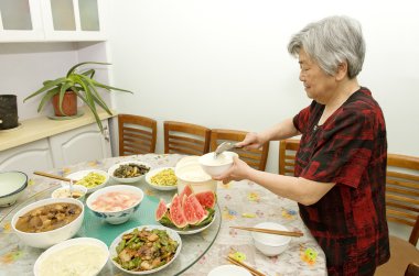 Grandmother is preparing dinner clipart