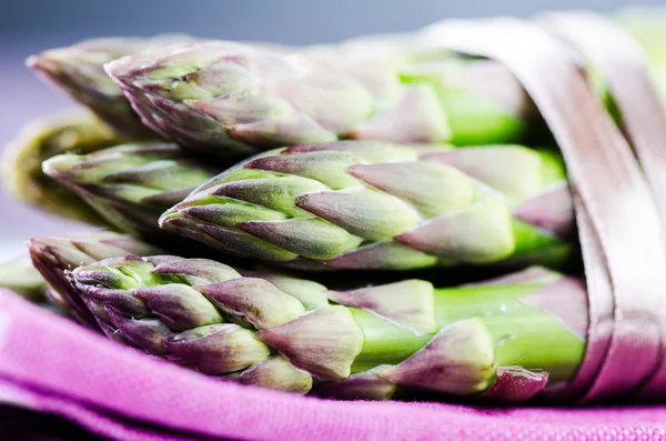 Bunch of asparagus on purple napkin close up — Stock Photo, Image