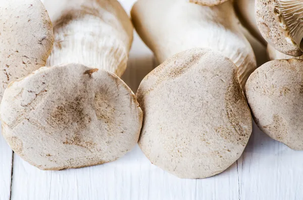 Stock image King oyster mushrooms on a white wooden table