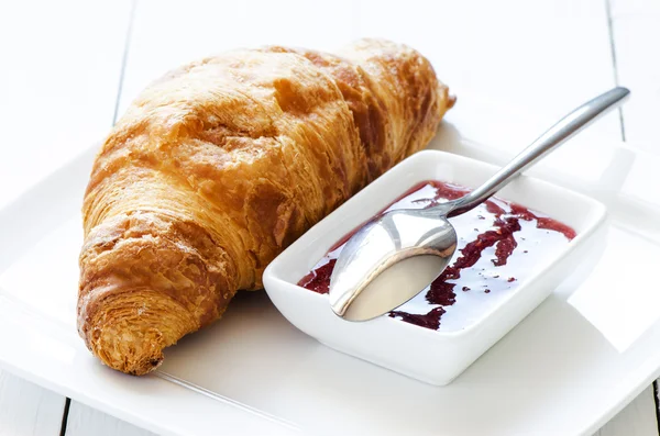 Croissant with raspberry jem — Stock Photo, Image