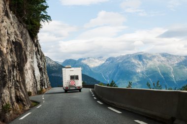 Road with motor home in mountains clipart