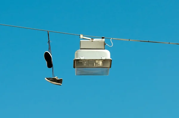 Street lamp and sneakers on blue sky — Stock Photo, Image