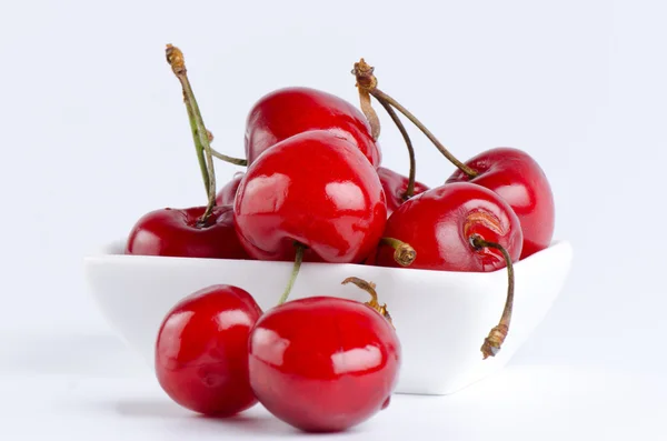 Bunch of cherries in a white bowl — Stock Photo, Image
