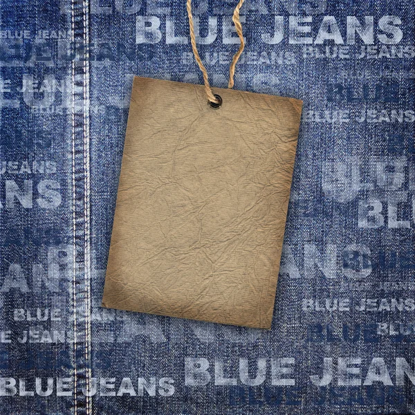 Background denim texture with cardboard label — Stock Photo, Image