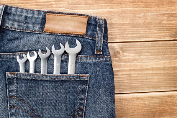 Wrenches in blue jeans pocket — Stock Photo, Image