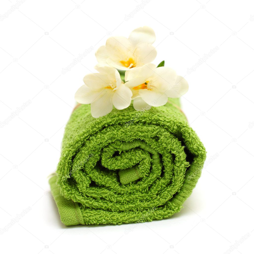 Spa concept - flower and green towel isolated