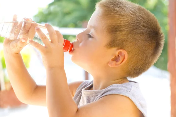 Little boy drinking water Stock Picture